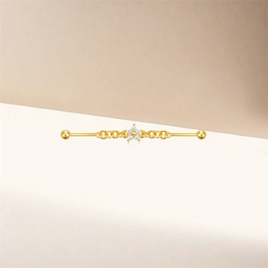Detail of gold industrial barbell with star moon chain and sparkling flower charm