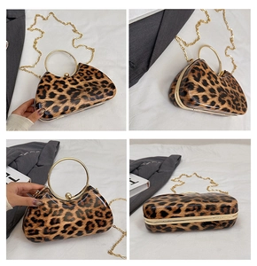 Detail view of leopard print evening box bag with golden round handle and chain strap