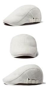 Detail of linen flat cap featuring breathable textured fabric and adjustable metal side buckle