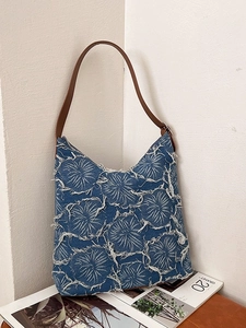 Washed denim tote bag with white frayed flower pattern and brown leather straps