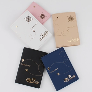 Flat lay of colorful PU leather passport covers with gold stamped lettering and textures
