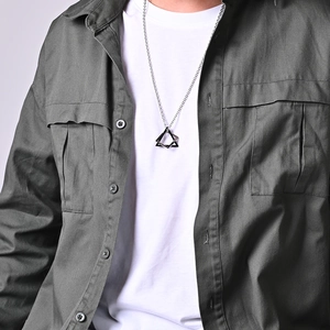 Close-up of geometric triangle pendant necklace in silver titanium steel on neck