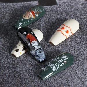 Detailed view of Christmas nail art stickers featuring Santa, reindeer and snowflakes