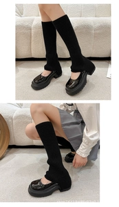 Detail of black knitted leg warmers paired with platform Mary Jane shoes in Y2K style