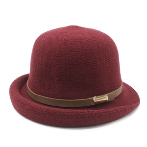 Fashionable dark red knit bucket hat with brown leather band and gold buckle detail