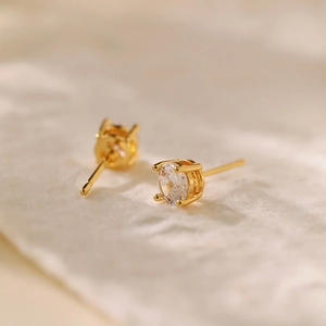 Minimalist gold plated stud earrings with sparkling round zircon in a four-prong setting