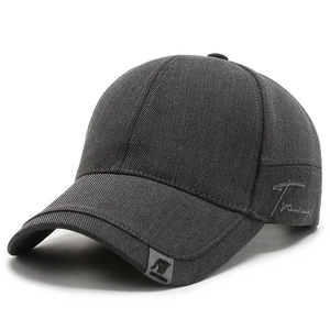 Detailed close-up of dark grey cotton twill baseball cap with side script embroidery