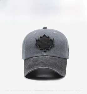 Front view of washed cotton baseball cap with a black maple leaf patchwork detail