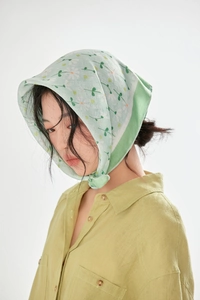 Light green cotton linen floral scarf tied as a headband with small white flower prints