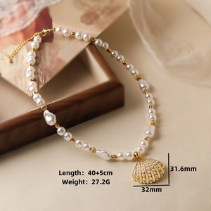 Detailed view of pearl necklace with vintage gold shell pendant showing 32mm size