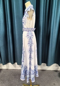Detail of blue and white printed sleeveless maxi dress with a matching patterned waist belt