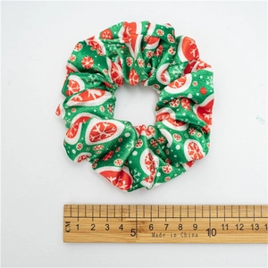Christmas plush scrunchie with snowflake patterns and red green colors for hair styling