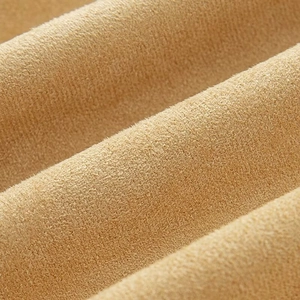 Detailed macro shot of premium brown suede jacket fabric showing soft texture and thickness