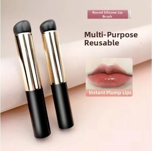 Macro detail of round silicone lip brushes with gold and black handles for precise blending