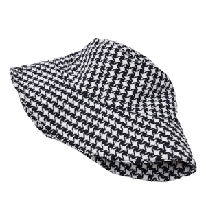 Detail of classic black and white houndstooth pattern on a thick wool bucket hat for autumn