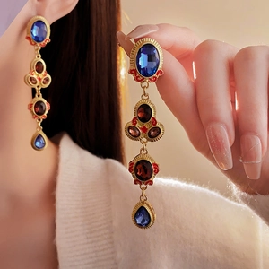 Detail of vintage French tassel earrings with gold metal and deep blue waterdrop crystals