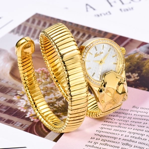 Close-up of gold snake-shaped watch bracelet with white dial and diamond bezel detail