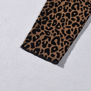 Close-up of leopard print mesh fabric showing delicate hem stitching and flocking texture