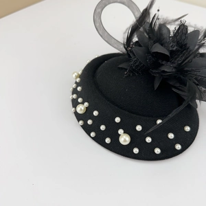 Vintage black fascinator hat with elegant mesh veil feathers and white pearls accessory