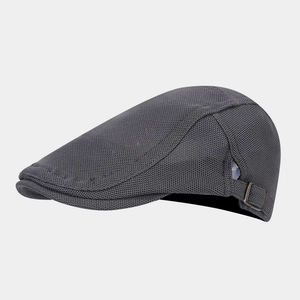 Detail of dark grey newsboy cap showing breathable mesh texture and adjustable side metal buckle