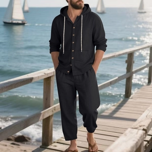 Men's black linen beach suit with hooded long sleeve shirt and matching trousers on a pier
