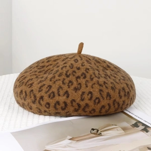 Close-up of leopard print wool beret fabric texture and vintage stem design