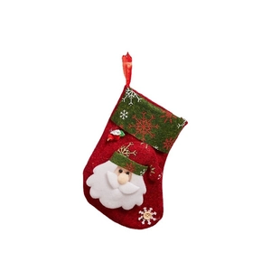 Red felt Christmas stocking with Santa Claus 3D character and green snowflake cuff