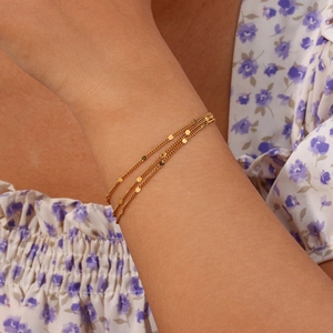Detail of 18K gold plated multi-layer chain bracelet with polished round sequins