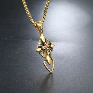 Golden stainless steel cross pendant necklace with a central red gemstone for men