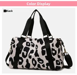 Detail of waterproof Oxford travel bag featuring black and white cow print and gold buckles