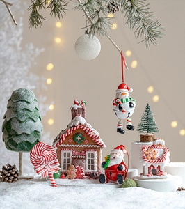 Detail of Christmas tree ornaments including gingerbread house and Santa figurines