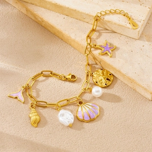 Gold-plated ocean theme bracelet with purple starfish, seashell pendants and pearls