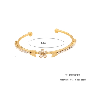 Detailed view of stainless steel flower and butterfly bangle with 6.5cm inner diameter