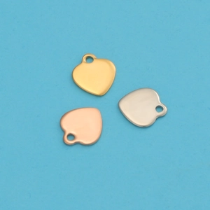 Polished heart pendants in gold, rose gold, and silver on a light blue background