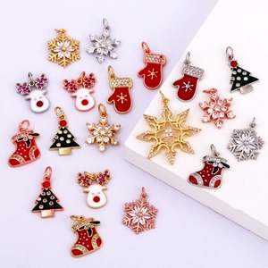 Detailed collection of gold plated Christmas charms including snowflakes and reindeer