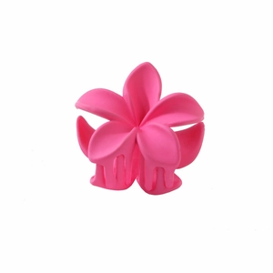 Close-up of matte pink plumeria flower hair claw clip with detailed petals and grip