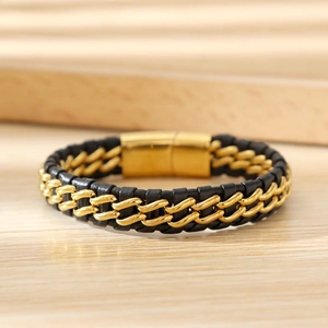 Detail of woven black leather bracelet with gold metal chain and magnetic clasp
