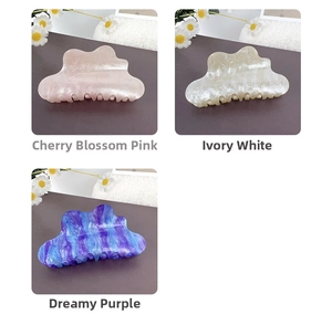 Detailed view of elegant cloud-shaped acrylic hair claws in cherry pink and dreamy purple