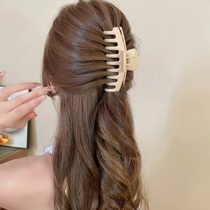 Beige matte square hair claw clip worn on head showing soft minimalist styling and texture