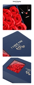 Detail of blue jewelry gift box with red roses, necklace, earrings and I LOVE YOU gold foil