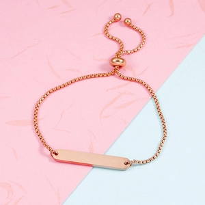 Detailed macro view of adjustable rose gold box chain bracelet with mirror finish bar