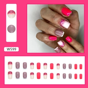 Detail of pink press-on nails set featuring glitter gradients and French tips design