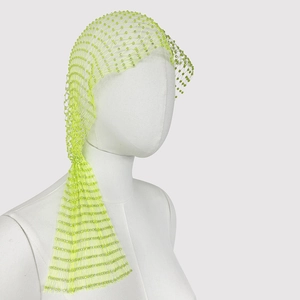 Detail of neon green mesh headpiece with sparkling rhinestones and hollow net design