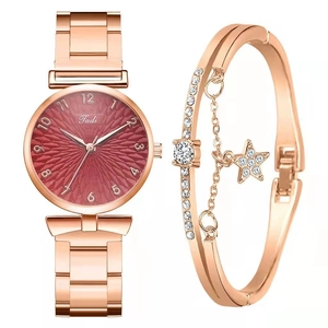Detail of rose gold women's watch and matching star bracelet set on white background