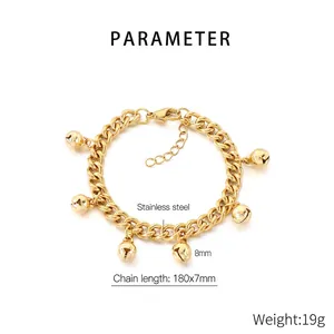 Detailed macro view of 18K gold plated stainless steel bracelet with tiny bell charms