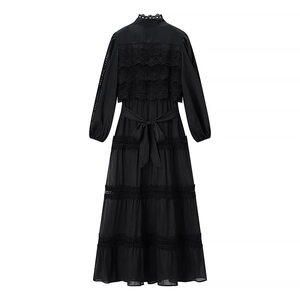 Detailed back view of a black French crochet dress with lace inserts and tie waist