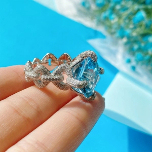 Asscher cut aquamarine topaz ring with micro-paved sparkling stones and chain band design
