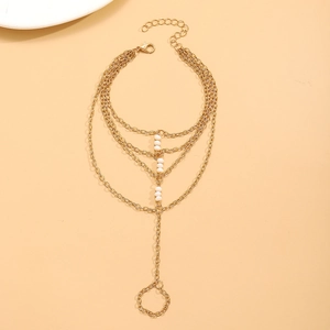 Detail of gold multi-layer chain hand harness with delicate white beads and extension