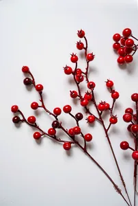 Detail of glossy red artificial berries and brown branches for festive DIY decoration