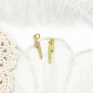 Macro shot of 18K gold plated lightning charms with micro-pave crystals for DIY jewelry